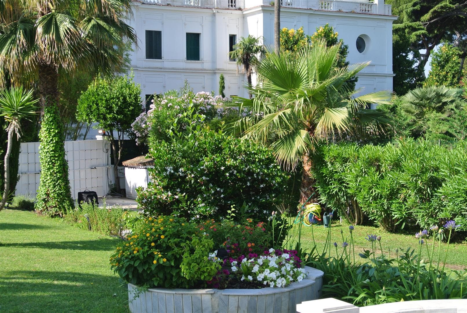 Historic villa with large Mediterranean garden and flower beds