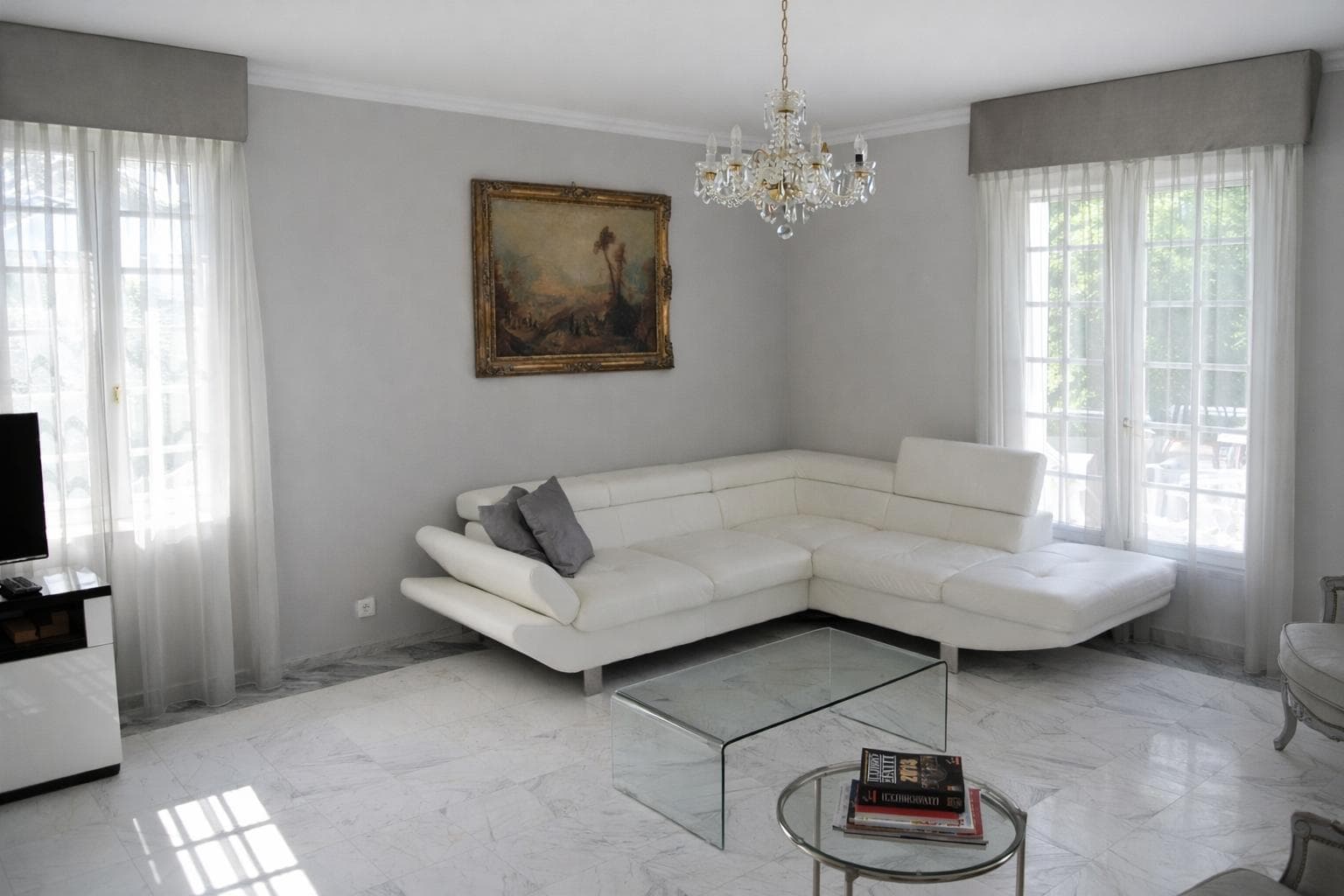 Elegant designer living room with corner sofa and garden view