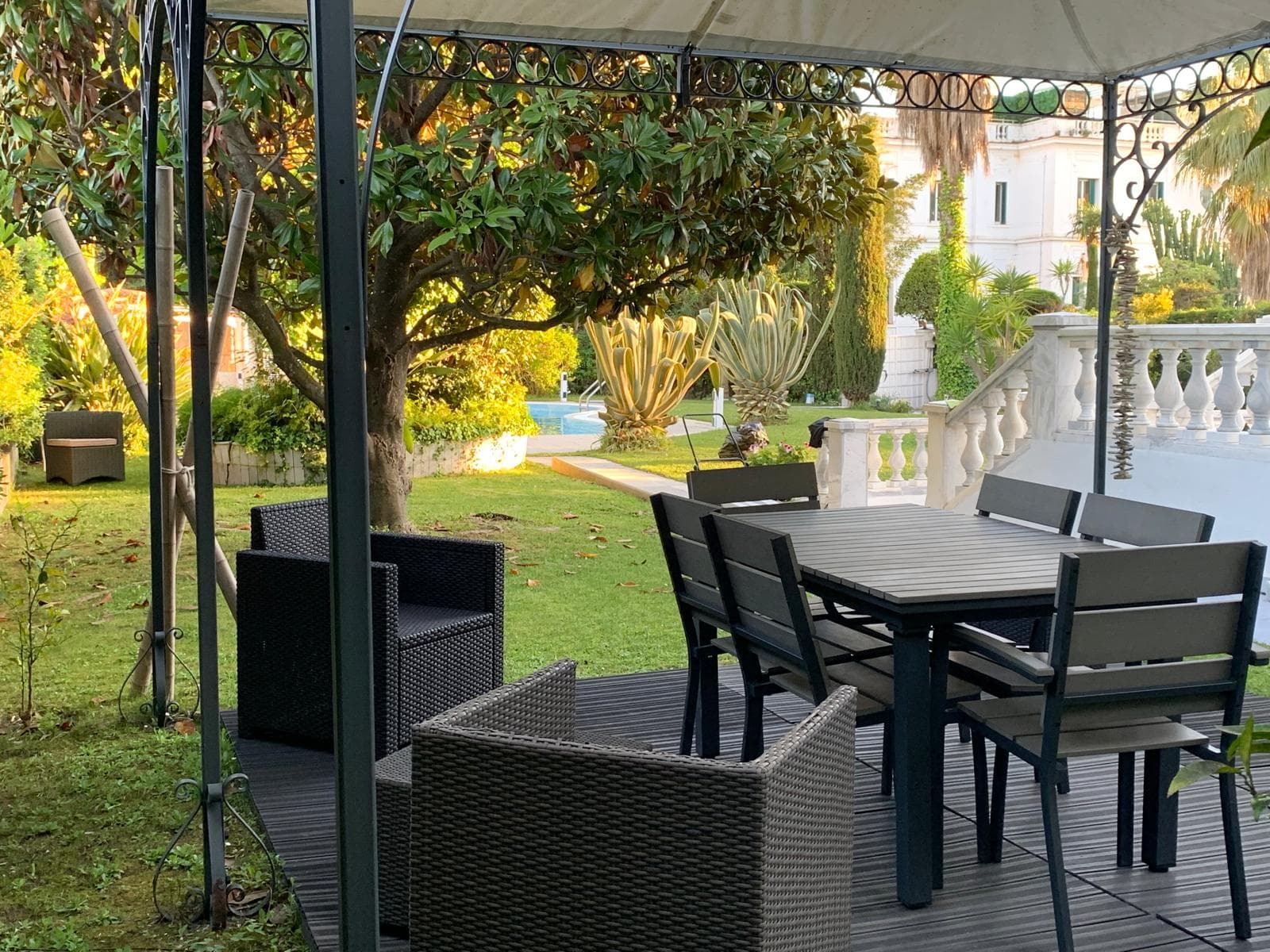 Second outdoor dining area with garden view